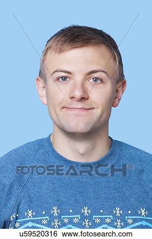 Close-up portrait of young man in sweater against blue background View Large Photo Image Stock Photograph - Close-up portrait of young man in sweater against blue background. Fotosearch