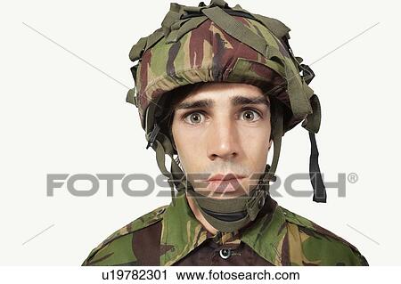 Close-up portrait of young soldier staring against gray background View Large Photo Image Stock Image - Close-up portrait of young soldier staring against gray background. Fotosearch