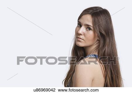 Stock Image - Close-up portrait of young woman over white background. Fotosearch