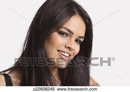 Close-up portrait of young woman smiling over white background View Large Photo Image Stock Photo - Close-up portrait of young woman smiling over white background. Fotosearch