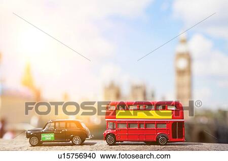 Stock Image - Close-up view of public transport figurines with Big Ben in the background. Fotosearch