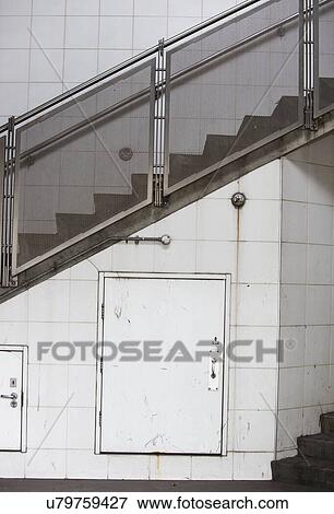 Stock Photo - Closed door on wall and stairway. Fotosearch