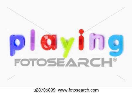Stock Photo - Colorful alphabet magnets spelling 'playing' over white background. Fotosearch