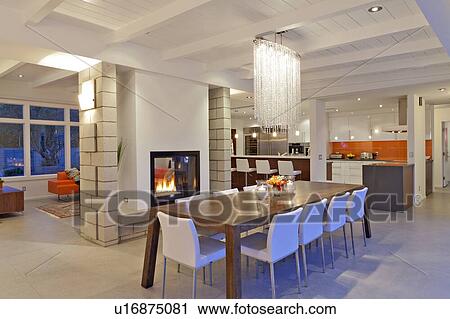 Stock Image - Contemporary chandelier in modern dining room of luxurious villa. Fotosearch