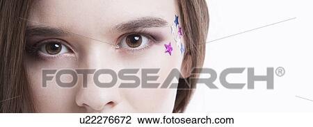 Cropped image of beautiful young woman with stars on her face against white background View Large Photo Image Stock Image - Cropped image of beautiful young woman with stars on her face against white background. Fotosearch