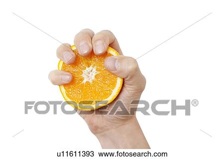 Stock Image - Cropped shot of a hand holding sliced juicy orange against white background. Fotosearch
