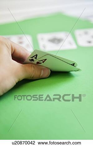 Cropped shot of hand holding aces of hearts and clubs on green surface View Large Photo Image Stock Image - Cropped shot of hand holding aces of hearts and clubs on green surface. Fotosearch
