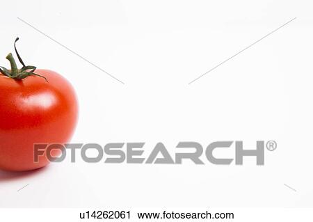 Stock Image - Cropped shot of tomato over white background. Fotosearch