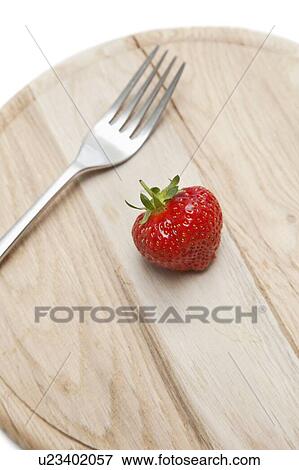 Cropped shot of wooden plate with strawberry and fork on it View Large Photo Image Stock Photo - Cropped shot of wooden plate with strawberry and fork on it. Fotosearch
