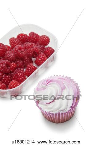 Picture - Cupcake with raspberries in container over white background. Fotosearch