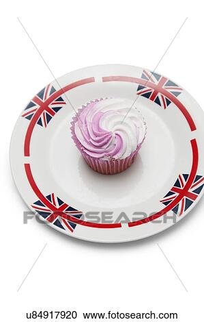 Stock Image - Delicious raspberry cupcake in plate over white background. Fotosearch