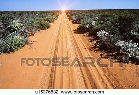 Stock Image - Desert road with van tracks in outback. Fotosearch