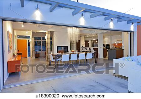 Stock Image - Dining room near patio in luxurious villa. Fotosearch