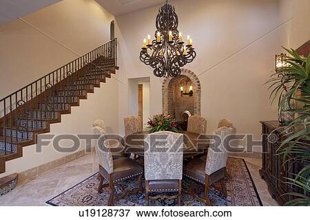 Dining room with candle chandelier in luxury mansion View Large Photo Image Stock Photo - Dining room with candle chandelier in luxury mansion. Fotosearch