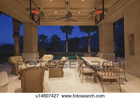 Dining table and chair in patio of mansion View Large Photo Image Stock Photo - Dining table and chair in patio of mansion. Fotosearch