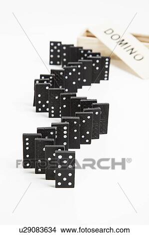 Picture - Domino tiles arranged in row. Fotosearch