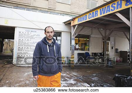 Stock Photograph - Employee washing vehicle at car wash. Fotosearch