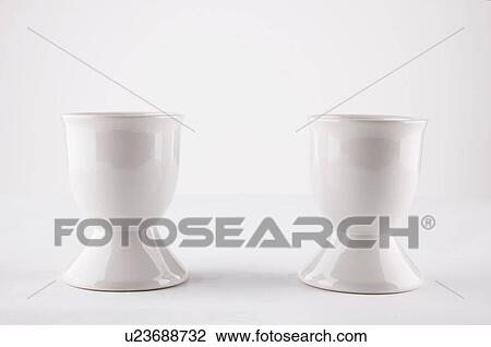 Empty egg cups side by side over white background View Large Photo Image Stock Image - Empty egg cups side by side over white background. Fotosearch