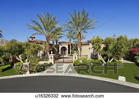 Stock Image - Entrance gate of luxury villa. Fotosearch