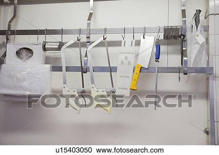 Stock Image - Equipment hanging at butcher shop. Fotosearch