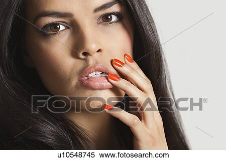 Stock Photography - Extreme close-up of sensuous young woman over white background. Fotosearch