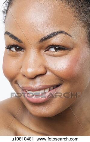 Extreme close-up of smiling young African American woman over white background View Large Photo Image Stock Image - Extreme close-up of smiling young African American woman over white background. Fotosearch
