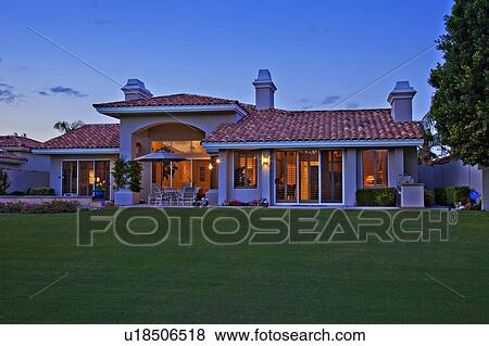 Stock Photo - Facade of luxurious villa with lawn in foreground. Fotosearch