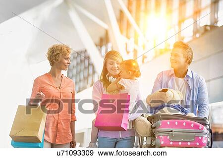 Family on holiday trip walking in airport View Large Photo Image Stock Photo - Family on holiday trip walking in airport. Fotosearch