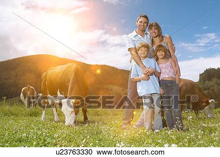 Stock Image - Farming family in countryside. Fotosearch