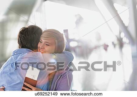 Stock Photo - Father reuniting with his daughter in airport. Fotosearch