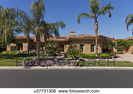 Stock Photo - Façade of bungalow across the road. Fotosearch