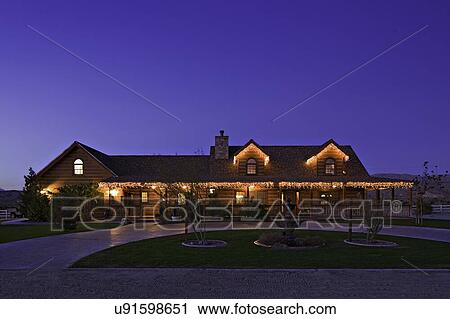 Stock Image - Façade of ranch home at dusk. Fotosearch