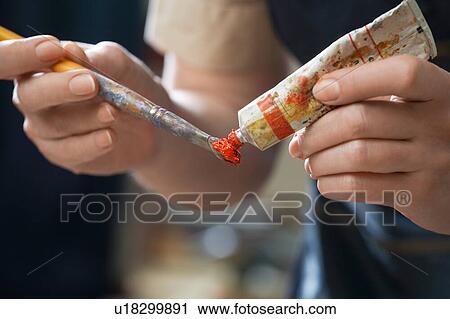 Female painter squeezing red paint on brush View Large Photo Image Stock Image - Female painter squeezing red paint on brush. Fotosearch