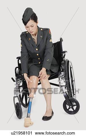 Female US military officer in wheelchair fitting prosthesis foot over gray backgrounds View Large Photo Image Stock Image - Female US military officer in wheelchair fitting prosthesis foot over gray backgrounds. Fotosearch