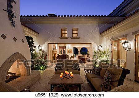 Fireplace with seating furniture in courtyard of luxury mansion in night View Large Photo Image Stock Photo - Fireplace with seating furniture in courtyard of luxury mansion in night. Fotosearch