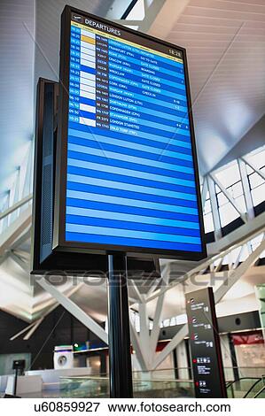 Stock Photo - Flight display monitor in airport. Fotosearch