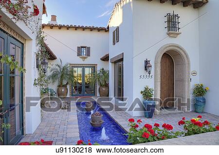 Stock Photo - Fountain in front courtyard of luxury manor house. Fotosearch