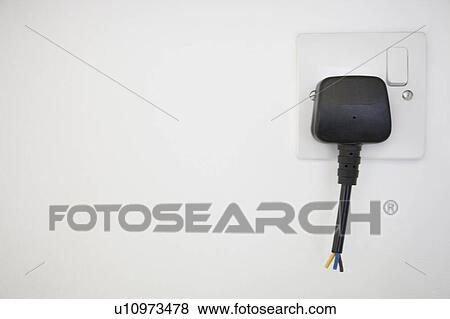 Frayed electrical cord with outlet attached on white wall View Large Photo Image Stock Photo - Frayed electrical cord with outlet attached on white wall. Fotosearch