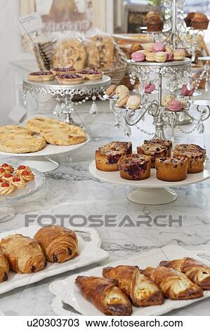 Stock Image - Fresh varieties of bread and sweet food at bakery. Fotosearch