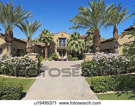 Stock Image - Front entrance facade of luxury villa. Fotosearch