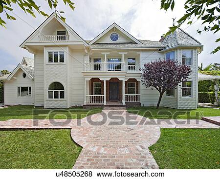 Stock Photo - Front view of Façade of traditional stylish house. Fotosearch