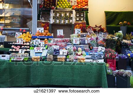 Stock Photo - Fruits and flowers for sale at store. Fotosearch