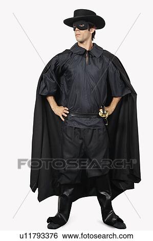 Full length of young man dressed as Zorro against gray background View Large Photo Image Stock Photograph - Full length of young man dressed as Zorro against gray background. Fotosearch