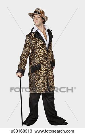Full length of young man in fur clothing against gray background View Large Photo Image Stock Image - Full length of young man in fur clothing against gray background. Fotosearch