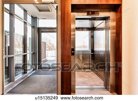 Stock Photo - Full length view of elevator in condominium. Fotosearch