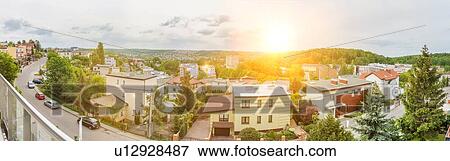 Stock Photo - Full length view of house rental business residence with lens flare in background. Fotosearch