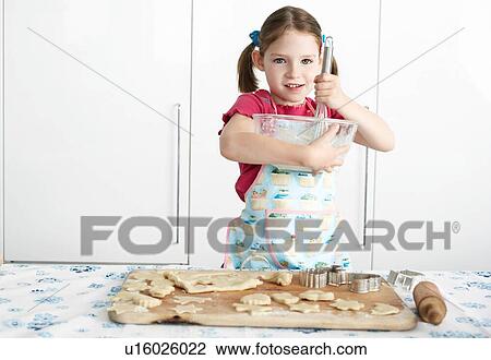 Girl preparing cookies in kitchen View Large Photo Image Stock Image - Girl preparing cookies in kitchen. Fotosearch