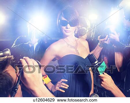 Stock Photo - Glamourous Woman Surrounded by Paparazzi. Fotosearch