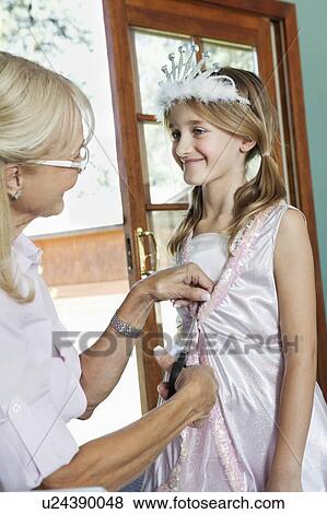 Grandmother dressing up granddaughter as princess View Large Photo Image Stock Photo - Grandmother dressing up granddaughter as princess. Fotosearch