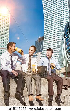 Group of colleagues sitting and talking while drinking coffee after work View Large Photo Image Stock Photography - Group of colleagues sitting and talking while drinking coffee after work. Fotosearch